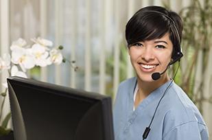 CareLine operator at computer answering a call.