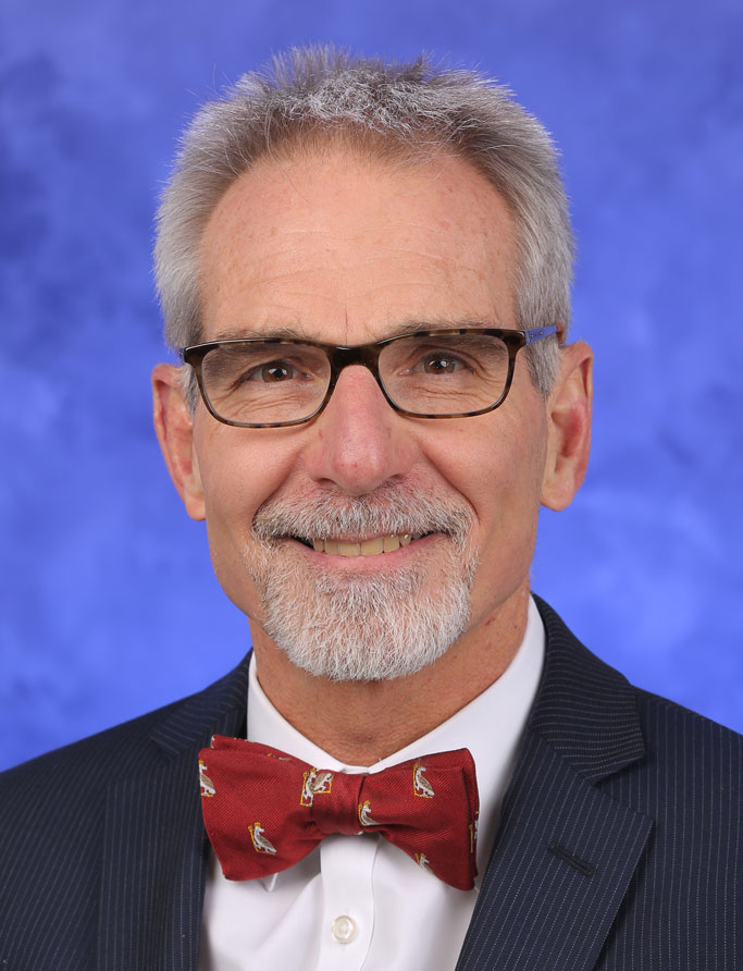 Berend Mets, MBChB, PhD, FRCA, FFA(SA), is Chair of the Department of Anesthesiology and Perioperative Medicine at Penn State College of Medicine. He is pictured in a dress shirt, bowtie and suit coat against a blue background.