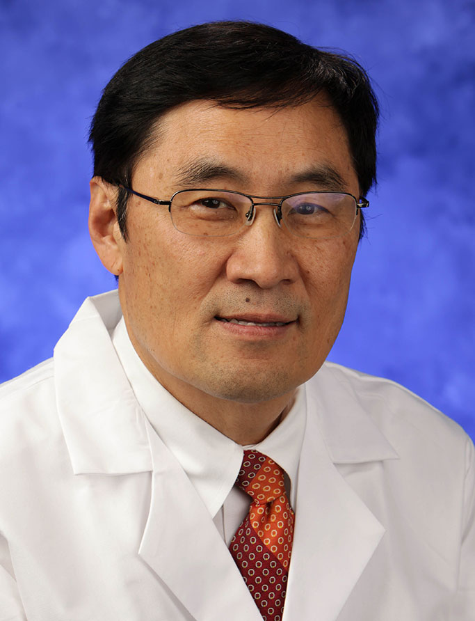 Thomas Ma, MD, PhD, is Chair of the Department of Medicine at Penn State College of Medicine. He is pictured in a medical coat, dress shirt and tie against a professional photo background.