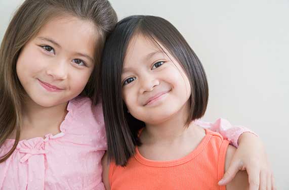 Two children hug at a Penn State Health Children’s Hospital Sibshops workshop