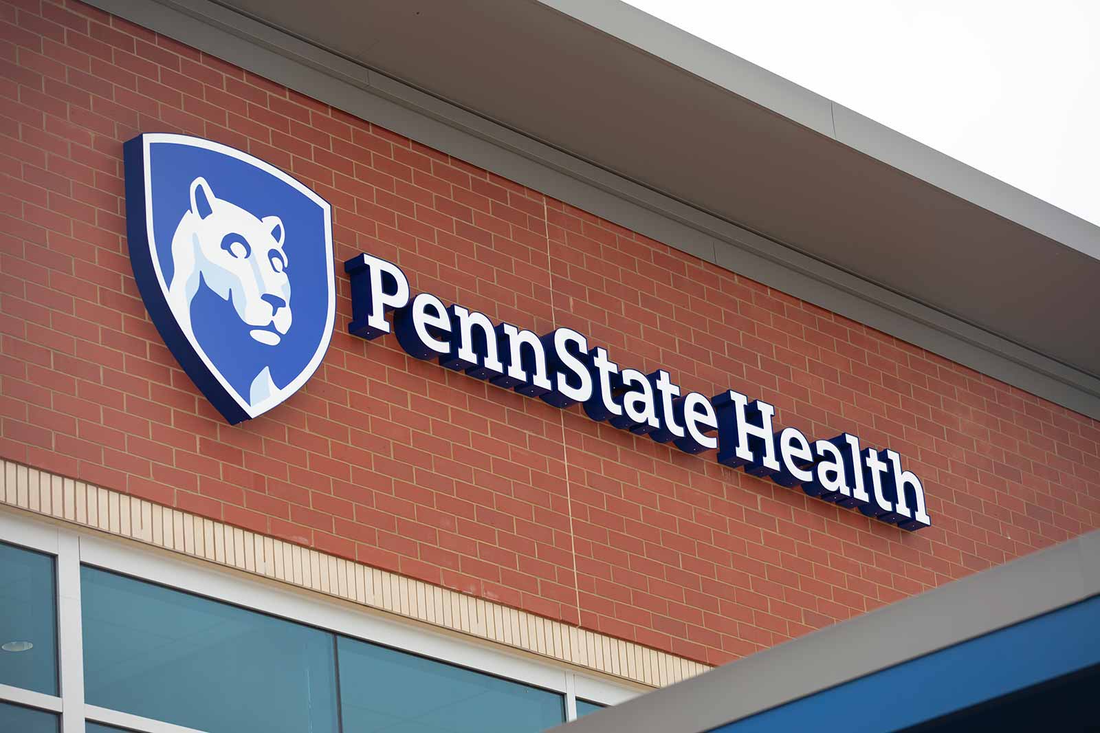 A close-view of the Penn State Health sign on the side a building.