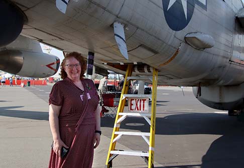Marina Perez stands in front of a vintage airplane outside of the MidAtlantic Air Museum.
