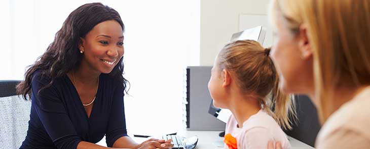 An Admissions employee at Penn State Children’s Hospital helps a patient check in.