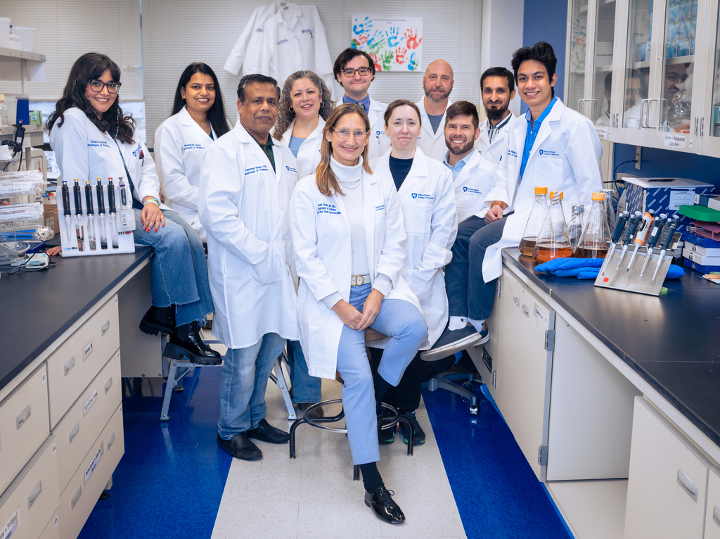 Dr. Giselle Saulnier Sholler and her team gather in their Penn State College of Medicine lab.