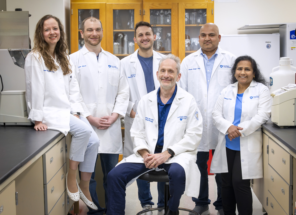 Six clinicians in hospital clothes are looking at the camera. Dr. Spiegelman is in the middle, bottom row.