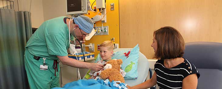 Doctor checks a patient's heart in a hospital room