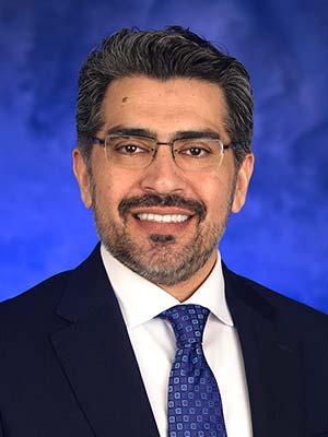 Umar Farooq, in a professional head and shoulders photograph.