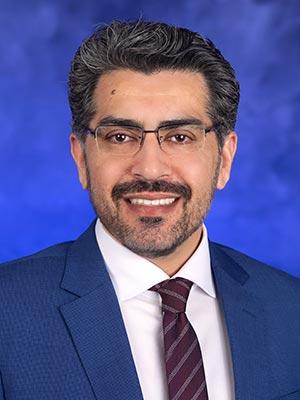 Umar Farooq, in a professional head and shoulders photograph.