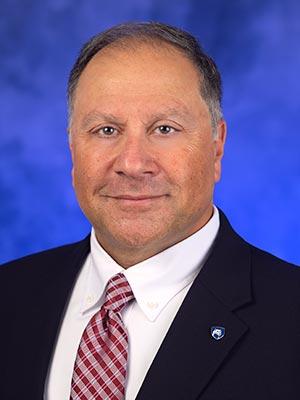 Maher Hanna, in a professional head and shoulders photograph.