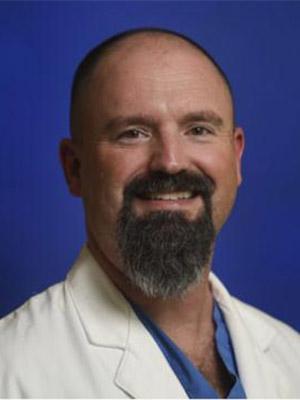 Dr. Joel Baker pictured in a professional head and shoulders photograph