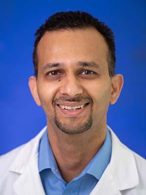 Dr. Kartik Shah, in a professional head and shoulders photograph.