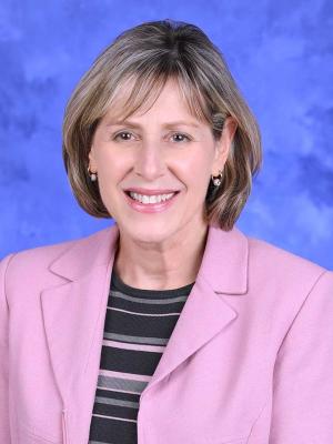 A head-and-shoulders photo of Maria Baker, PhD, FACMG, MS, LGC