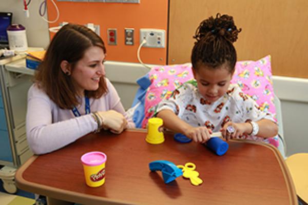 A child life specialist works with a patient