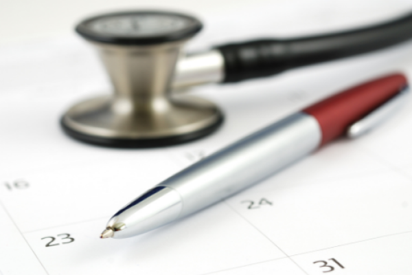 Stethoscope, calendar and pen