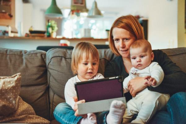 A mother and two children use the computer