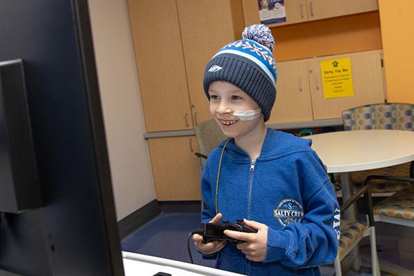 Young boy playing a video game.