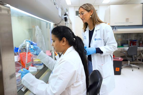 Image of two individuals inside a lab.