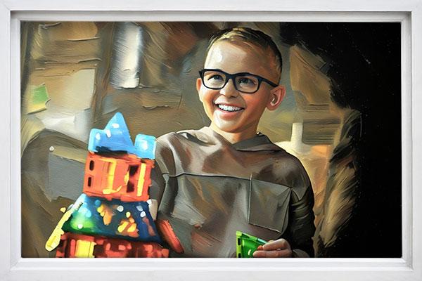 Young male with a big smile on his face playing with toys.