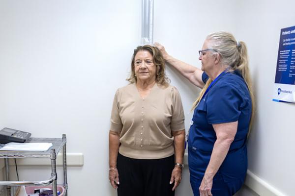 Deborah Dunn, left, is measured by Carlette Gable, a medical assistant at Penn State Health Medical Group – Middletown.