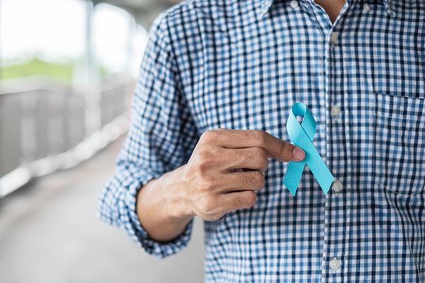 Midsection of Man Holding Blue Ribbon.