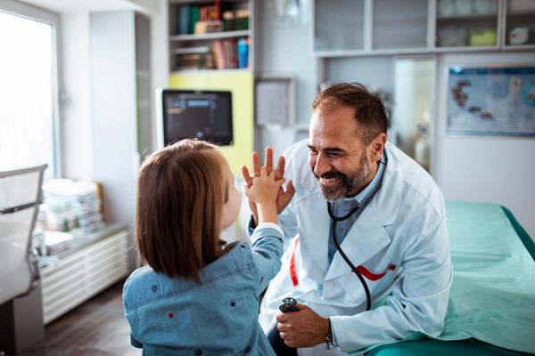doctor high-fiving pediatric patient 
