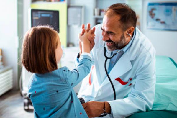 Pediatric doctor giving high five to child