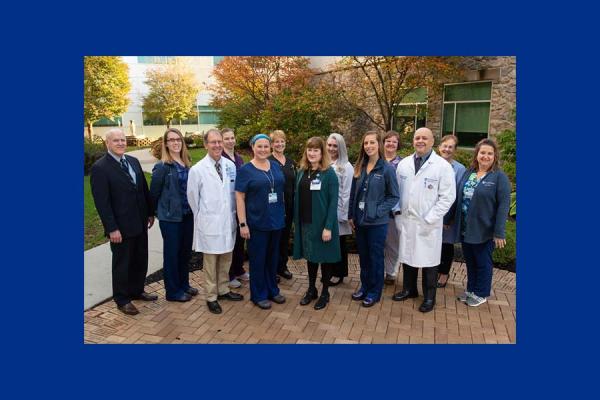 A group photo of several Penn State Health St. Joseph Medical Center staff as they stand outdoors.