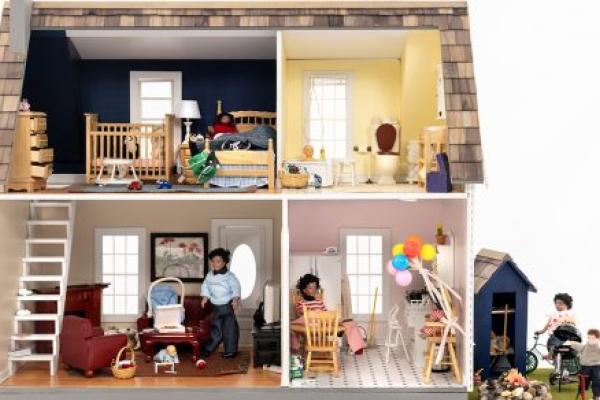 A dollhouse shows common household hazards in the bedroom, bathroom, living room, kitchen and backyard.