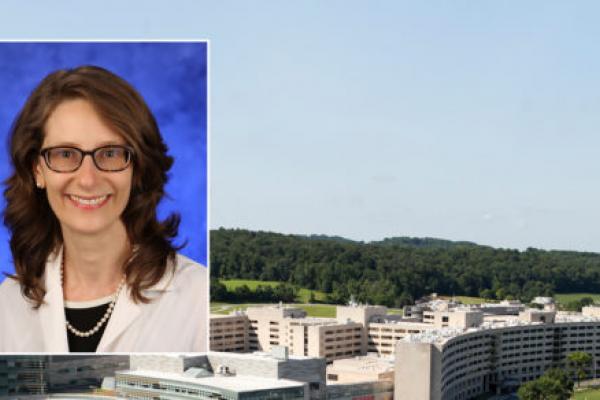 A head and shoulders professional portrait of Dr. Erika Saunders against a background image of Penn State College of Medicine and Penn State Health Milton S. Hershey Medical Center.
