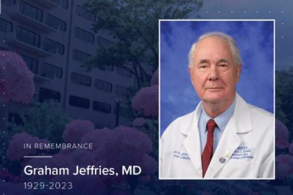 Portrait of the late Dr. Graham Jeffries in doctor's coat, on a gradient memorial background