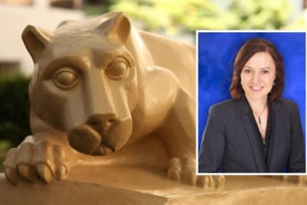 A nittany lion statue rests with its paws over a stone ledge on a college campus, with greenery and buildings blurred in the background. An inset headshot in the corner shows a woman with shoulder-length brown hair wearing a dark blazer and smiling against a blue backdrop.