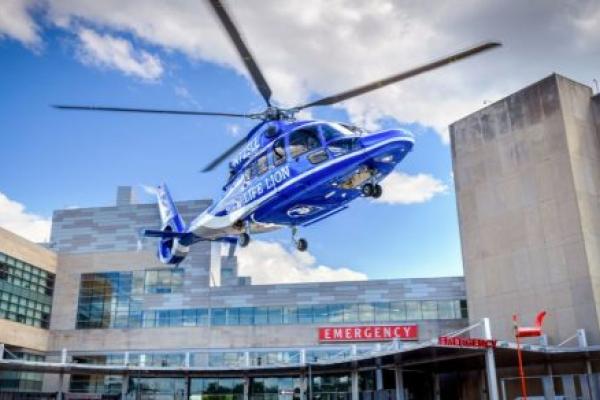 Life Lion medical helicopter approaching the helipad above the emergency department entrance at Penn State Health Milton S. Hershey Medical Center.