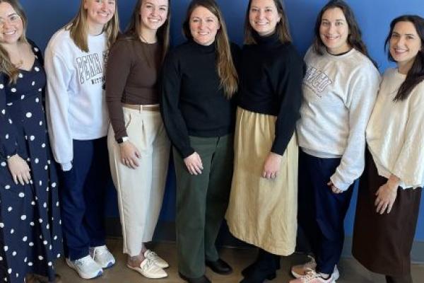 Seven members of the Pediatric Intermediate Care Unit at Golisano Children’s Hospital smile in a group photo.