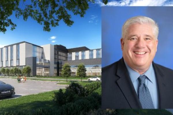 A headshot of Dr. Michael Reihart wearing a suit is placed over a rendering of the future Penn State Health Lancaster Medical Center.