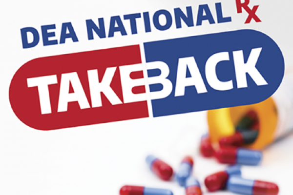 Graphic that says, “DEA National Rx Takeback” over a pill shape. In the background is a prescription bottle that has been knocked over with pills spilling out.