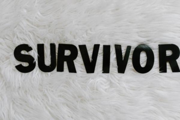 Words that spell out survivor in black inck