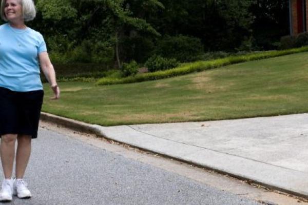 Older woman walking on a sidewalk
