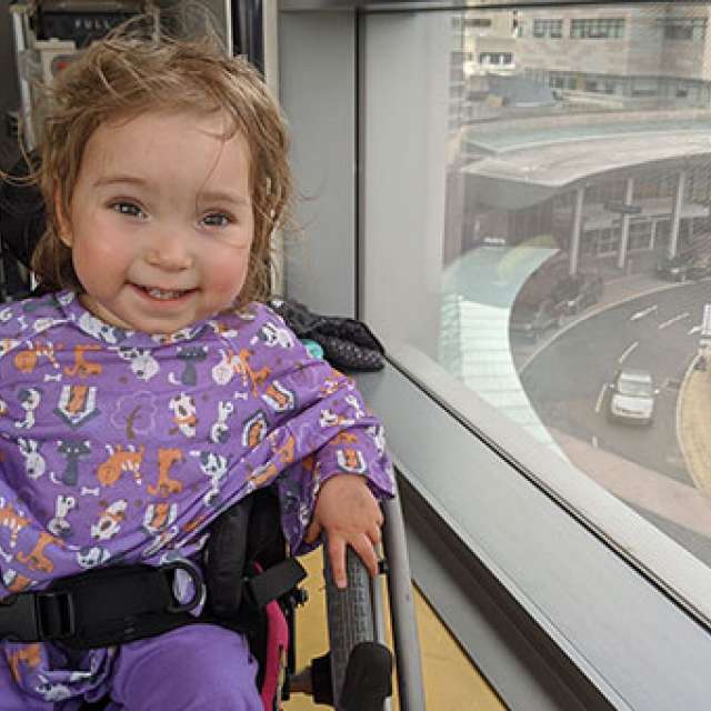 Young girl smiling in her wheelchair