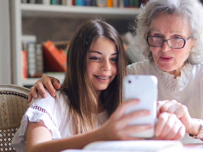 A granddaughter and grandmother use the OnDemand app