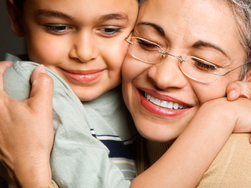 grandmother and grandson embracing.