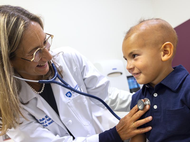 Dr. Giselle Saulnier Sholler examines patient Ford Bartle.