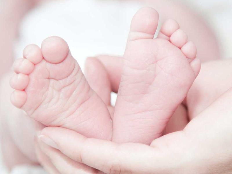Close-up of Hands Holding Baby Feet