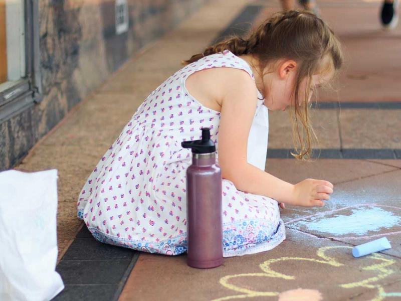 Girl Drawing on the Floor Using Chalks